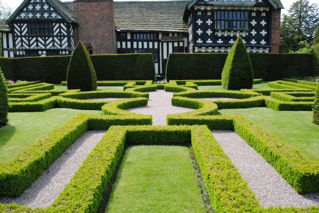 green grass lawn near brown brick house