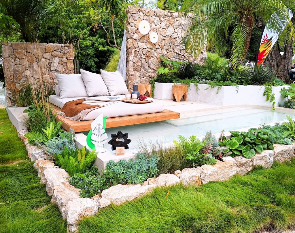 A bed sitting on top of a lush green field